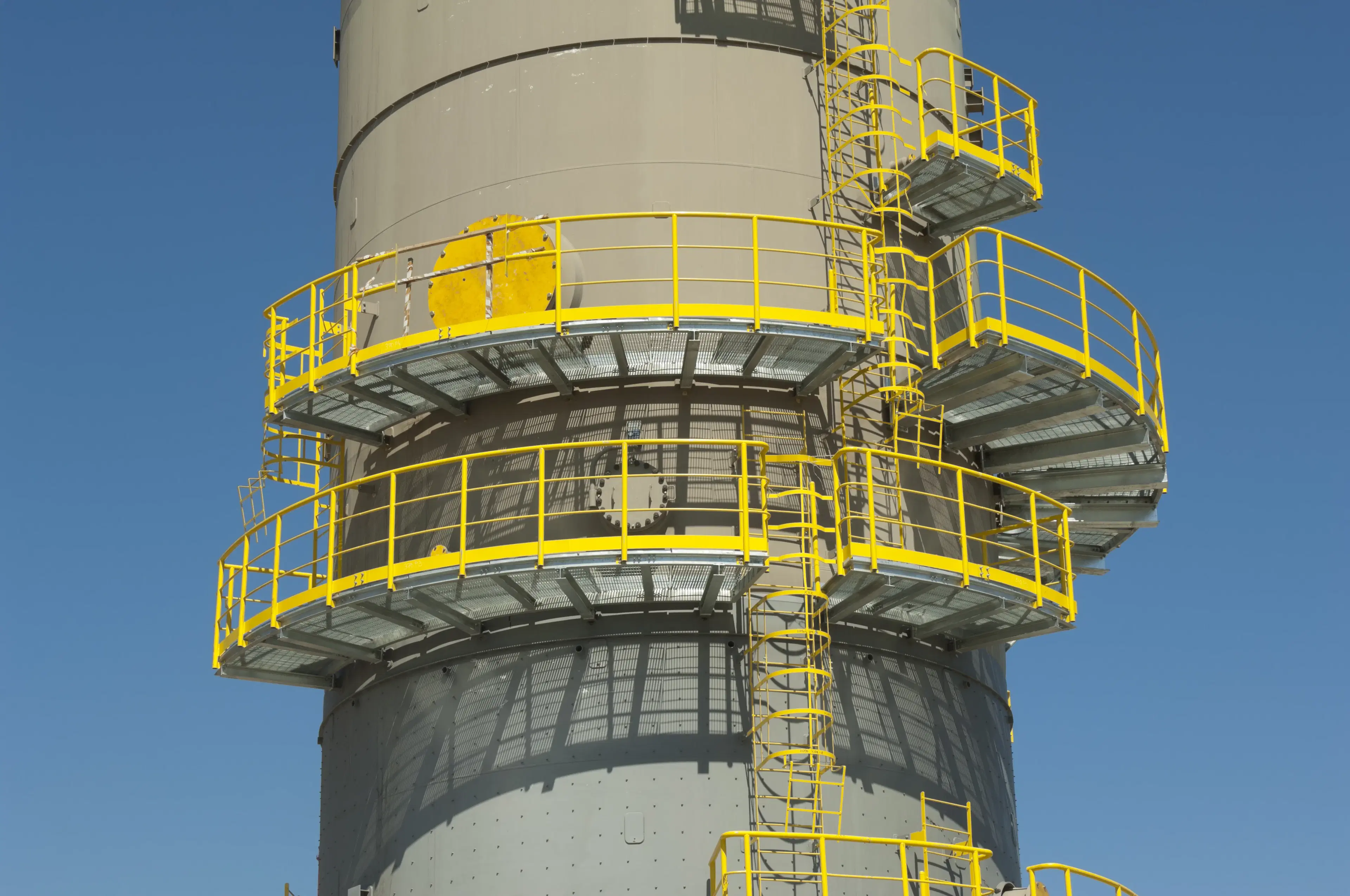 Circular steel grating platforms around an industrial vessel