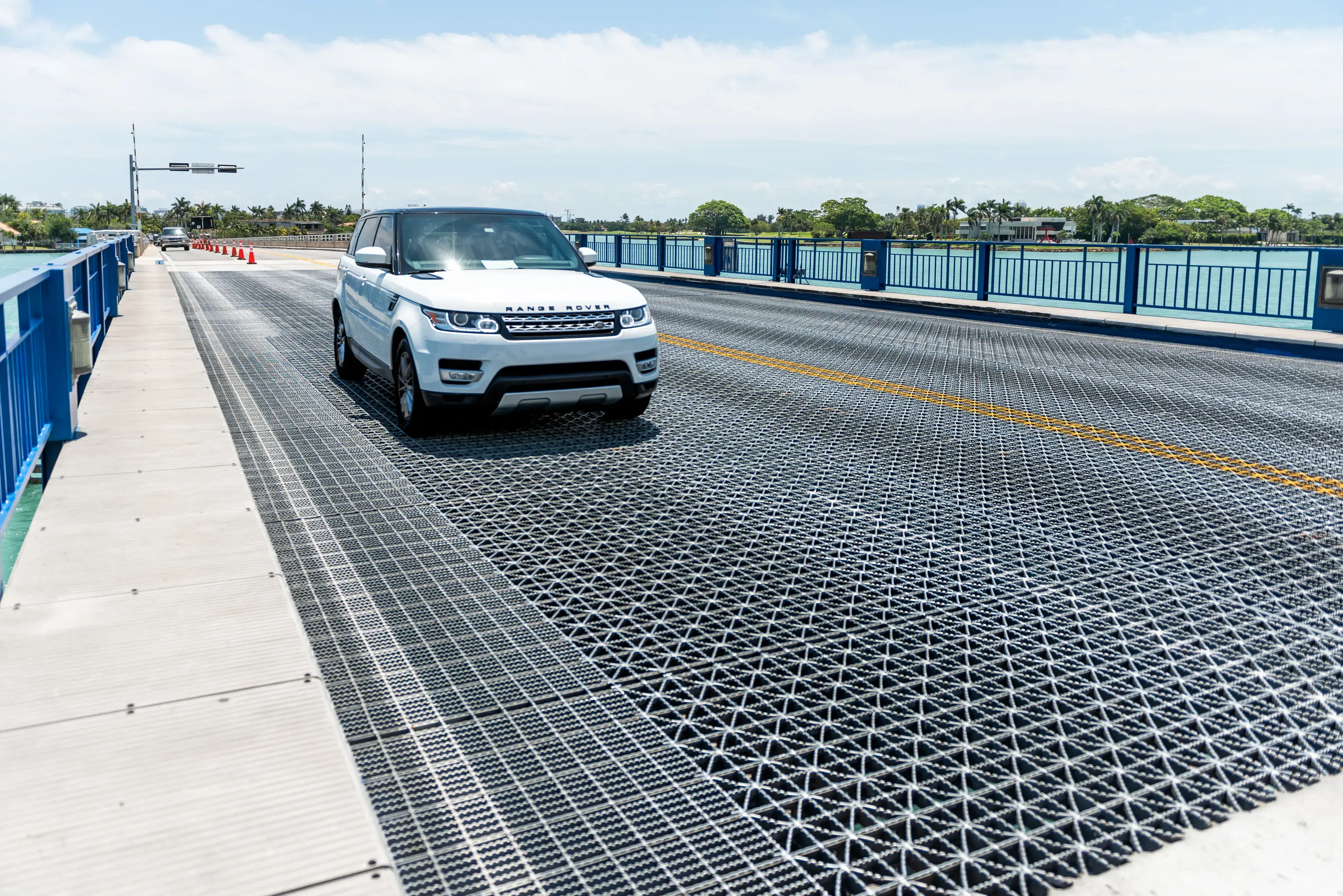 Open-grid steel bridge deck carrying vehicle traffic